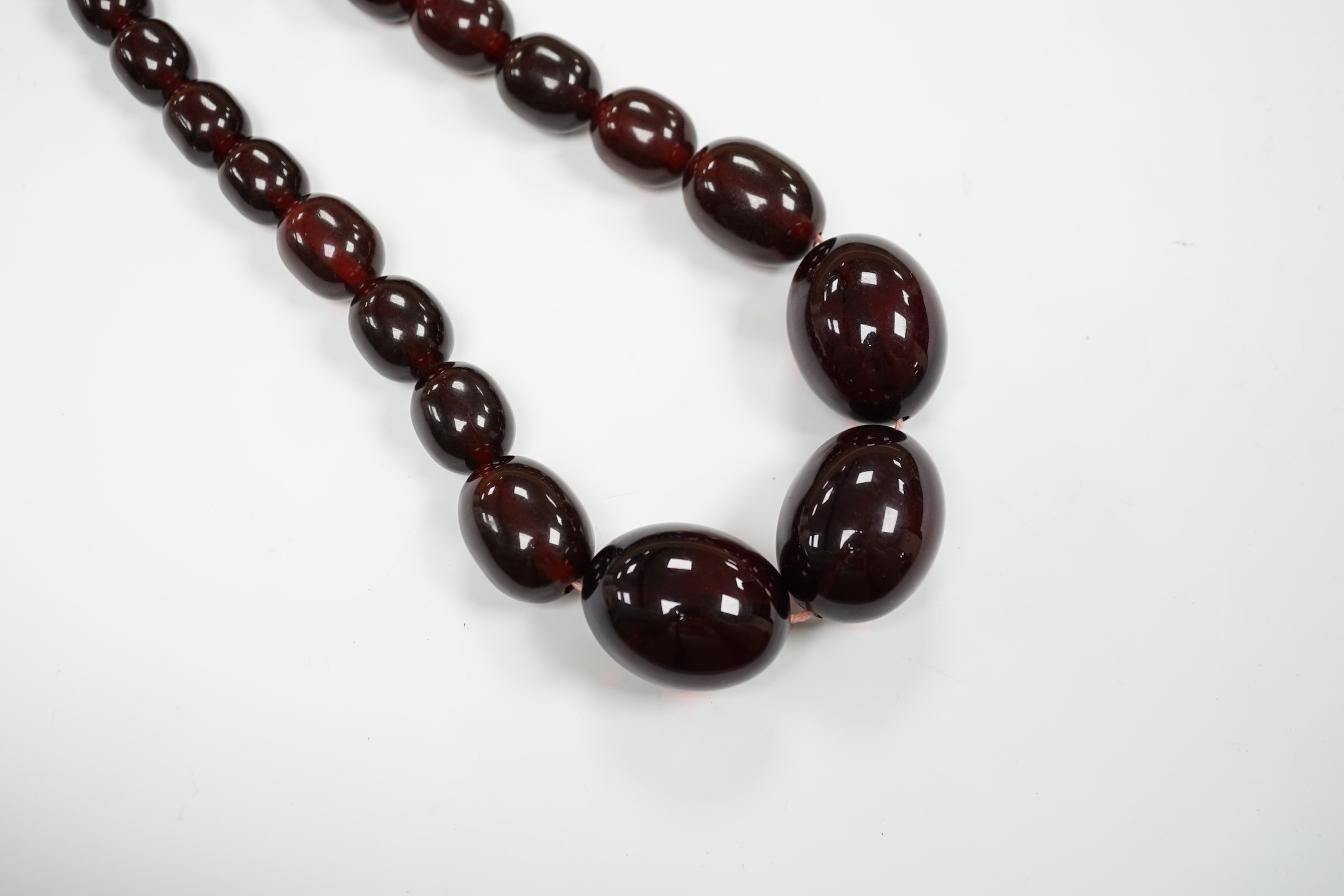 A single strand graduated simulated cherry amber bead necklace, 68cm, gross weight 151 grams.